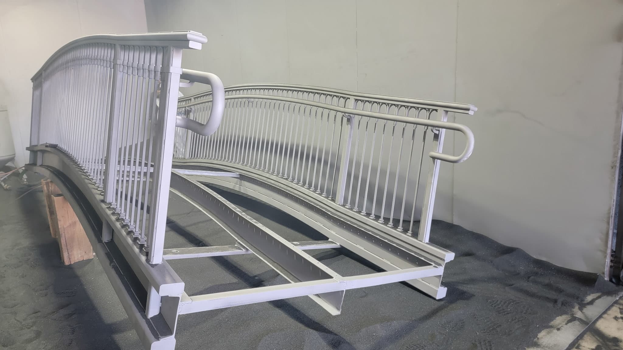 Arched Steel Pedestrian Bridge Over Water Feature