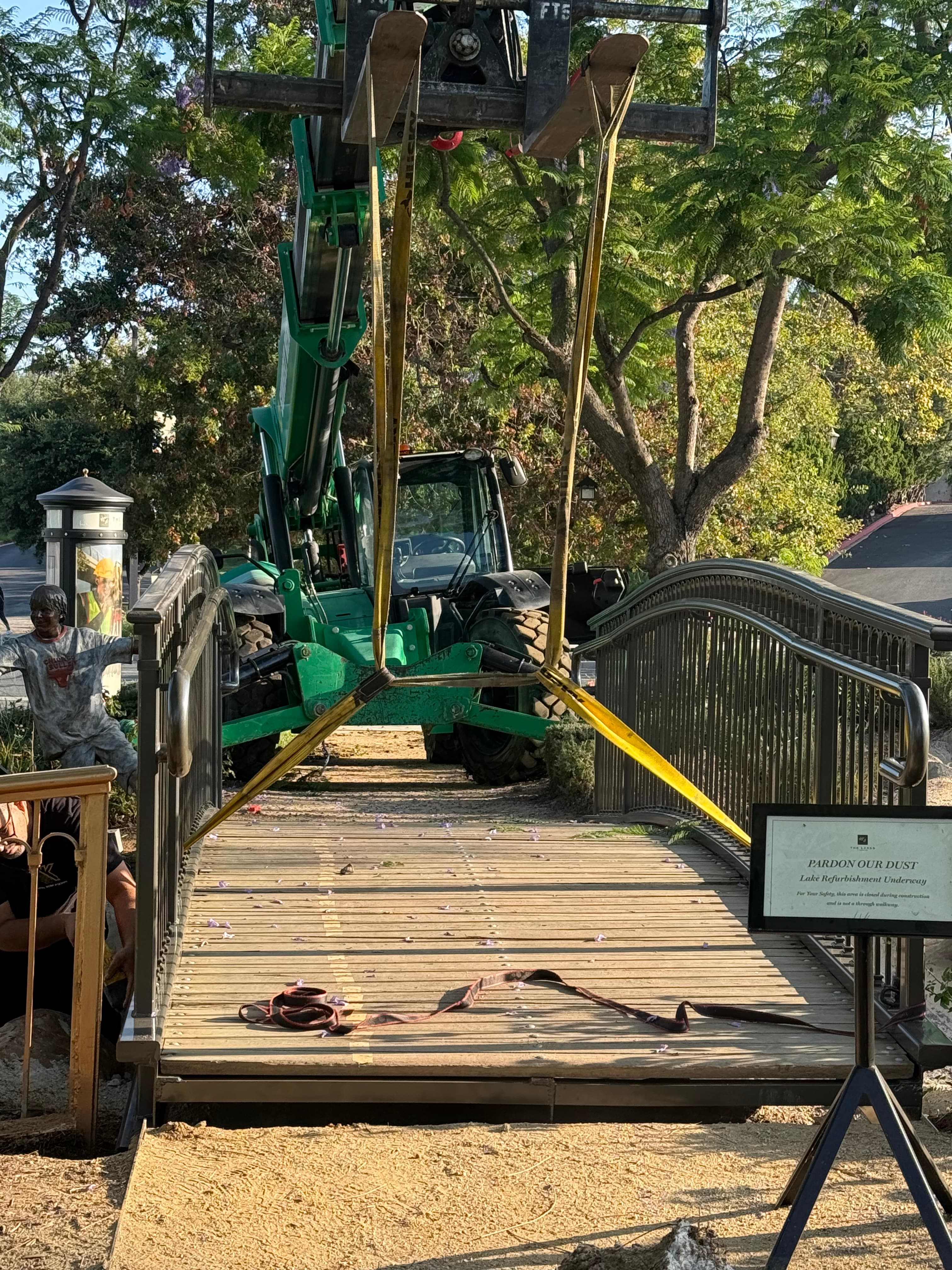 Arched Steel Pedestrian Bridge Over Water Feature